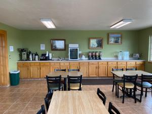 a room with tables and chairs and a kitchen at Americas Best Value Inn Kadoka in Kadoka