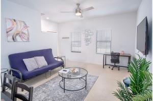 a living room with a blue couch and a table at BRAND NEW 2 Stylish 3BR Near Exciting Downtown in San Antonio