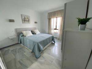 1 dormitorio blanco con 1 cama con manta azul en Apartamento Las Mimosas Beach 2, en La Cala de Mijas 20 fotos más