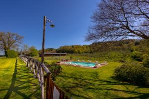 a fence next to a swimming pool in a yard at Tenuta Risalpiano in Pelago