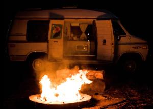 Una caravana está estacionada junto a un incendio. en Van Camping - Do Something Different!, en Landrum