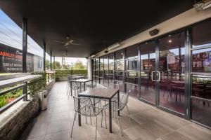 a restaurant with tables and chairs on a patio at Nightcap at Ashley Hotel in Braybrook