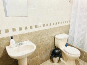 La salle de bains est pourvue de toilettes et d'un lavabo. dans l'établissement Apartamento en el Centro de Trujillo - Primer Piso, à Trujillo