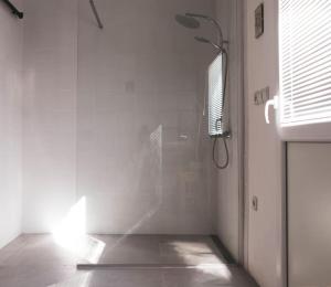 a shower with a glass door in a bathroom at Kmetija Pečnik in Prevalje
