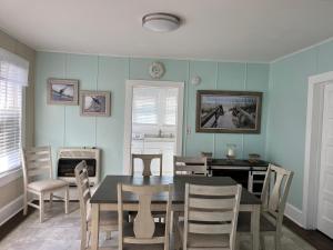 a dining room with a table and chairs at Nock Apartments in Ocean City