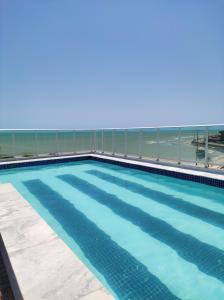 a swimming pool on top of a building at Bluesunset in João Pessoa