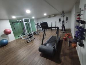 a gym with treadmills and exercise equipment in a room at Bluesunset in João Pessoa