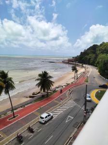 a view of a beach with a white car on a road at Bluesunset in João Pessoa +2 photos