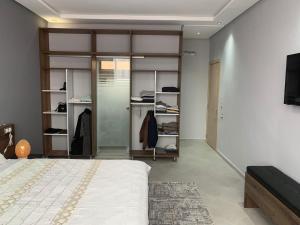 a bedroom with a bed and a walk in closet at Riad L'Aéroport in Marrakesh