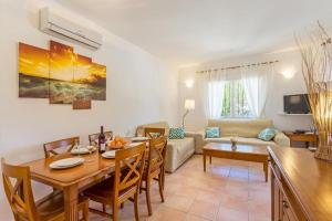 a living room with a table and a dining room at Monte Turquesa in Jávea