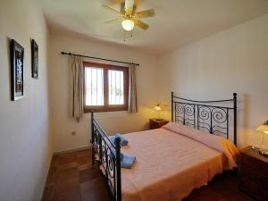 a bedroom with a bed and a ceiling fan at Villa Sophie 4 - by Holiday Rentals Villamar in Benitachell +56 photos