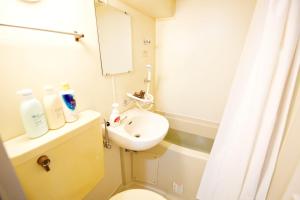 a bathroom with a sink and a toilet and a mirror at Crest YS Chiyoda 7C in Aoichō