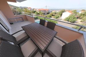 a balcony with a wooden table and chairs at Apartments BoBo in Kraj +53 photos