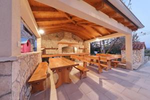an outdoor patio with wooden tables and benches at Apartments BoBo in Kraj