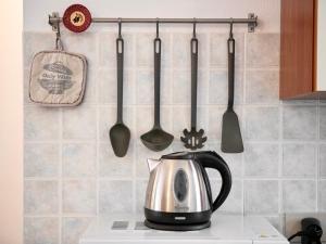 a kitchen counter with a tea kettle and utensils at A casa di Luca in Pula