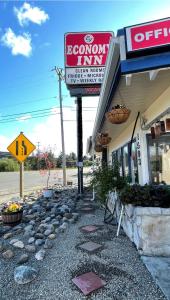 a sign for a popcorn inn next to a building at Economy Inn in Reedsport