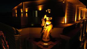 a statue of a woman on the side of a building at night at Sea Palm Otel Yalıkavak in Yalıkavak
