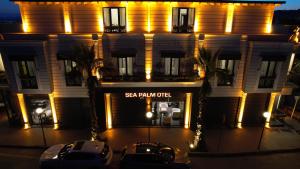 a building with a sign that reads sea palm oil at Sea Palm Otel Yalıkavak in Yalıkavak