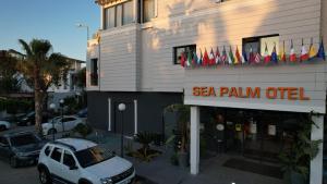 a car parked in front of a sea palma office at Sea Palm Otel Yalıkavak in Yalıkavak