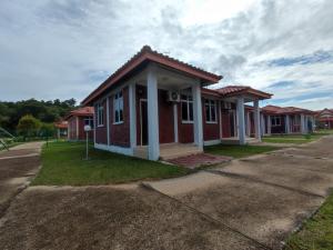 a small red brick house on a street at SENTA Adventure Camp & Resort in Kampong Minyak Beku