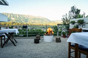 a fire pit with a view of a mountain at Patio Rooms Gjirokaster in Gjirokastër