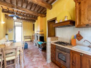 a kitchen with a sink and a stove top oven at Luxurious Holiday Home with Hill view in Asciano Tuscany in Asciano