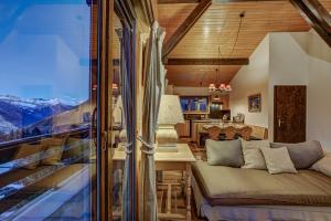 a living room with a couch and a table at Chalet Par le Travers in La Tzoumaz