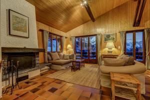 a living room with a couch and a fireplace at Chalet Par le Travers in La Tzoumaz