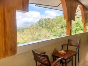 a table and chairs in a room with a window at Silverin Bajawa in Bajawa