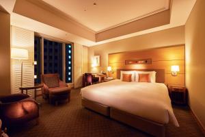 a hotel room with a large bed and a large window at Marunouchi Hotel in Tokyo