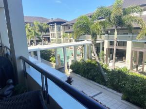 a balcony with a view of a resort at 208 Santai - Spacious Family Apartment by uHoliday in Casuarina