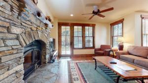 a living room with a large stone fireplace at Snowcreek VI The Lodges #1133 condo in Mammoth Lakes
