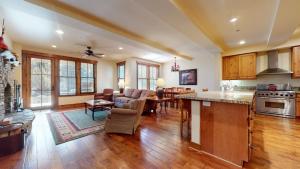 an open kitchen and living room with a table and a counter at Snowcreek VI The Lodges #1133 condo in Mammoth Lakes