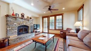 a living room with a couch and a fireplace at Snowcreek VI The Lodges #1133 condo in Mammoth Lakes +58 photos