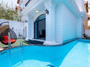a swimming pool in the backyard of a house at Pallas Villa in Vung Tau