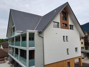 a white building with a black roof at hb-Gästehaus 