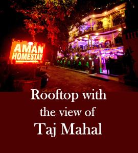 a sign that says roof top with the view of tag malial at Aman Homestay, A Boutique Hotel in Agra