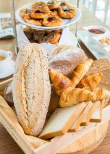 a tray of bread and pastries on a table at Eastin Grand Hotel Sathorn in Bangkok