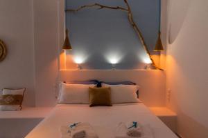 a bedroom with a bed with lights on it at studio lefkes kea in Vourkari