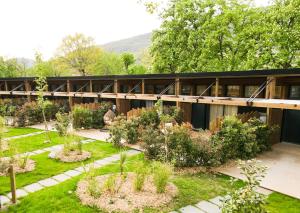 a building with a garden in front of it at Domaine le Vaxergues in Saint-Affrique