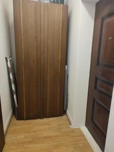 a closet with a wooden door in a room at Apartment Marija Bar in Bar