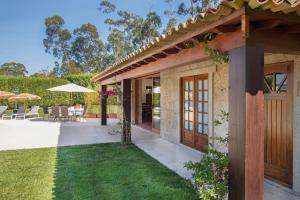 a house with a patio and a yard at VILLA 500 in Barcelos