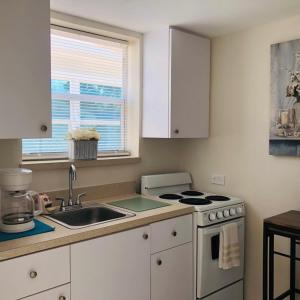 a kitchen with a sink and a stove top oven at Guayabita's House in Miami