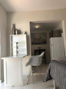 a bedroom with a white desk and a chair at Guayabita's House in Miami +12 photos