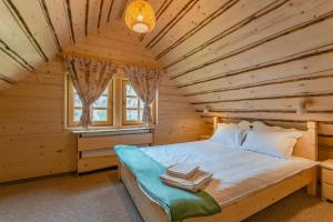 a bedroom with a bed in a wooden room at Cabane de Poveste in Bran