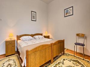 1 dormitorio con 1 cama de madera y 2 mesitas de noche en Apartment Lucija, en Kaštela