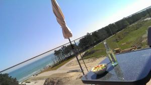 a bowl of food sitting on a table next to a beach at Meerblick Appartement Ostseebad Binz Prora direkt am Strand in Binz