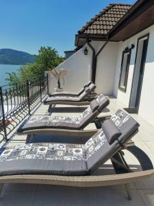 a pair of lounge chairs sitting on a deck at Casa Dorin in Orşova
