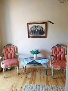 a living room with two chairs and a table at Maria's traditional house in Tríkeri