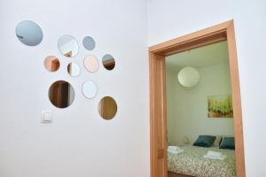 a wall with a bunch of mirrors on a wall at Apartman Buongiorno in Jajce
